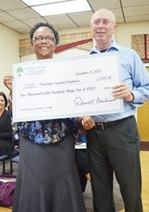 DAILY NEWS PHOTO/Randy Hammons Washington Parish School District Coordinator Olga Jackson (left) presents a check to Louisiana Special Olympics Director of Outreach and Area Management Charlie Courville. 