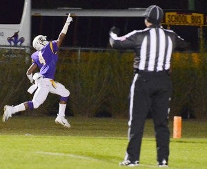 Franklinton running back Azende T. Magee points toward the sky as he scores a touchdown in the first quarter.