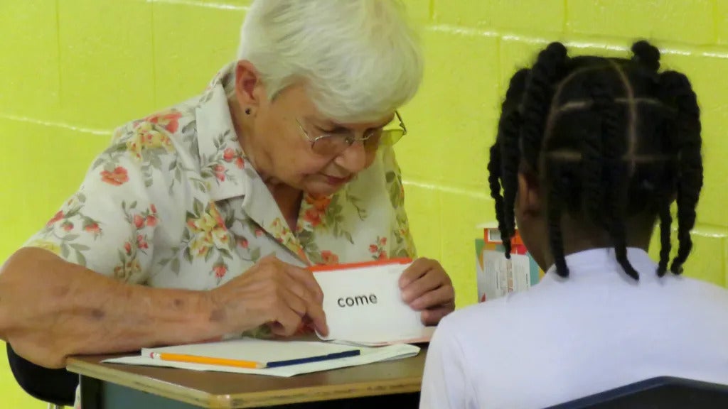 Lorraine Bourn showing flashcards to a 3rd-grade student at Central Elementary.